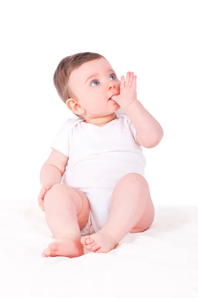 Meisje van de baby met vinger in haar mond. — Stockfoto