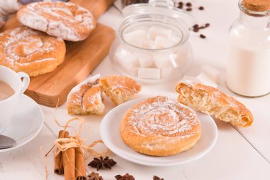 Beyaz tabakta krema kaplı tatlı hamur tatlısı.