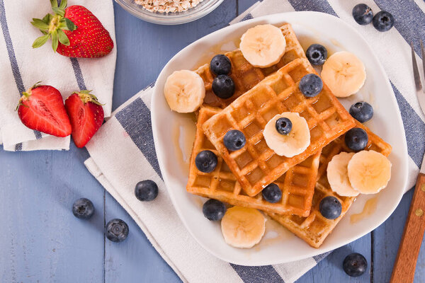 Waffles with blueberries, bananas and honey.