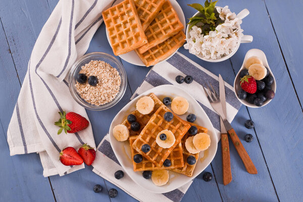 Waffles with blueberries, bananas and honey.