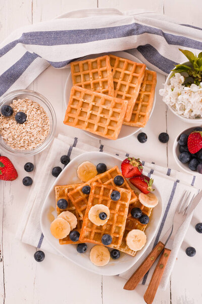 Waffles with blueberries, bananas and honey.