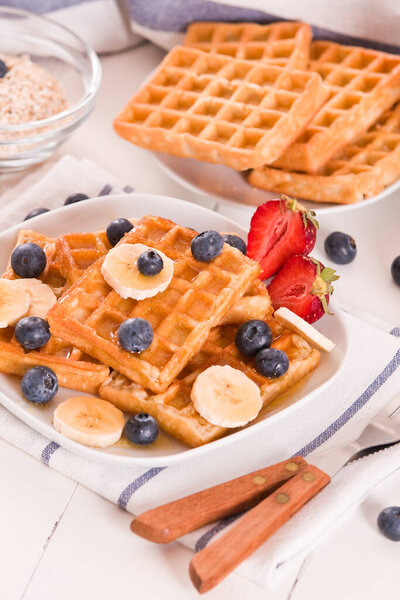 Waffles with blueberries, bananas and honey.