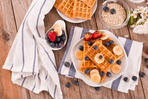 Waffles with blueberries, bananas and honey.