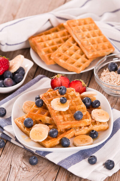 Waffles with blueberries, bananas and honey.
