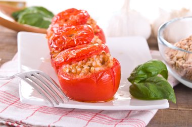 Doldurulmuş domatesler beyaz tabakta.