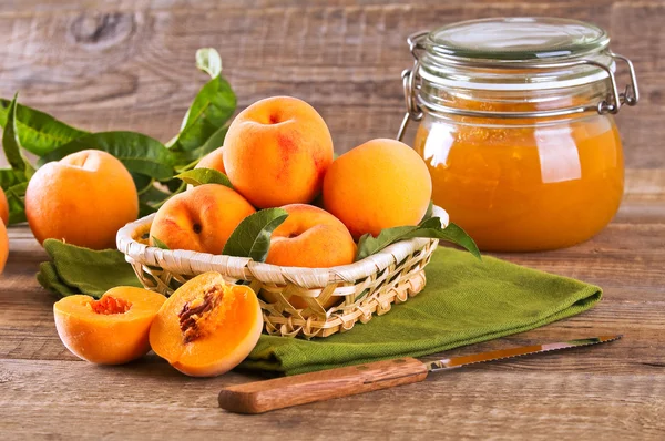 Oranje perziken in de mand. — Stockfoto