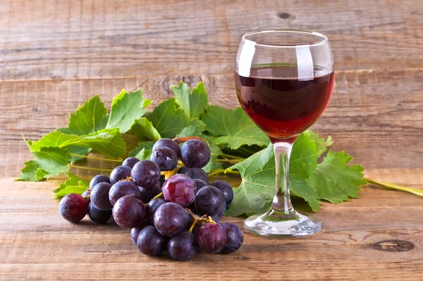 stock image Grapes with wine glass.