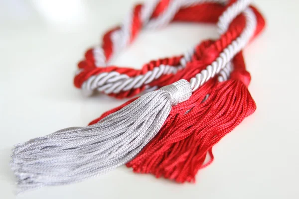 Grey and red ropes with tassel isolated — Stock Photo, Image