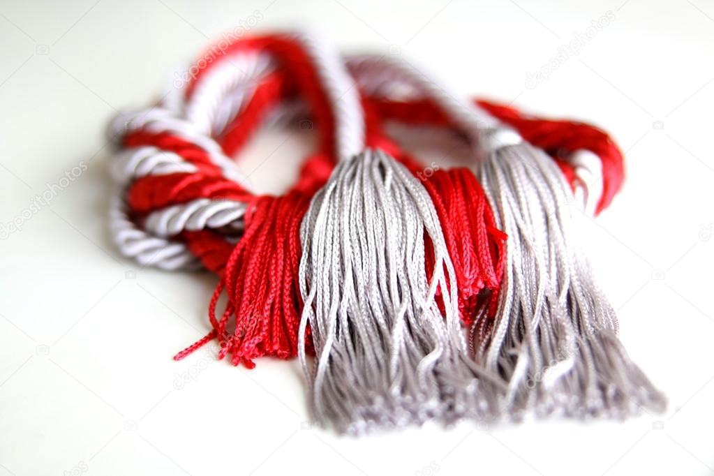 grey and red ropes with tassel isolated