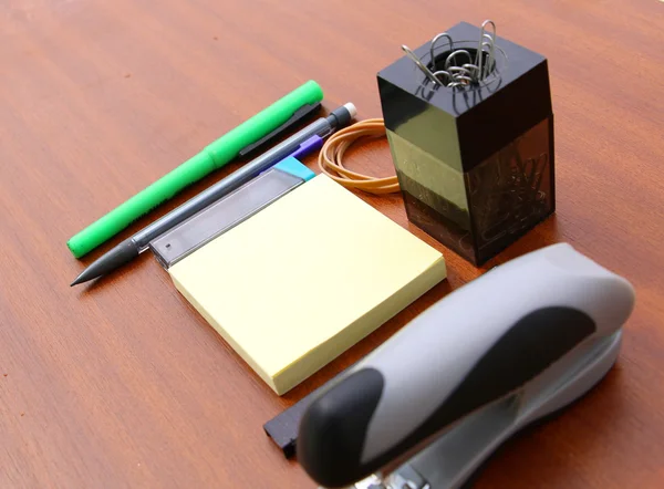 Office desk and tools over a brown — Stock Photo, Image