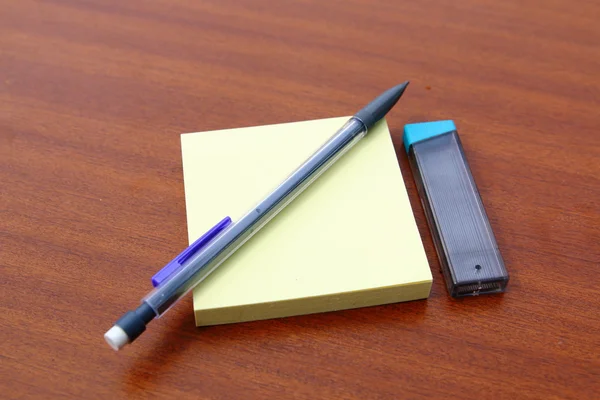 Yellow memo post and mechanical pencil — Stock Photo, Image