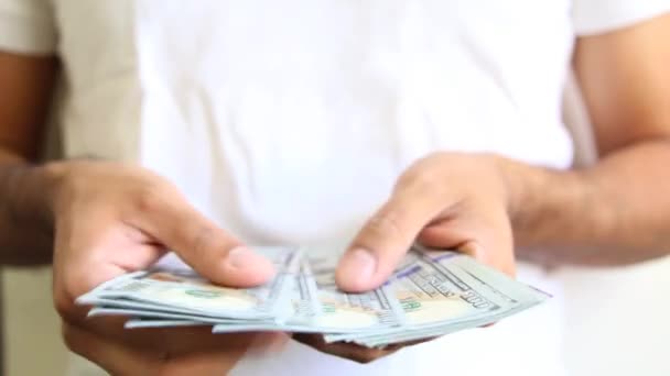 Close-up of a businessman's hands counting hundred dollar bills — Stock Video