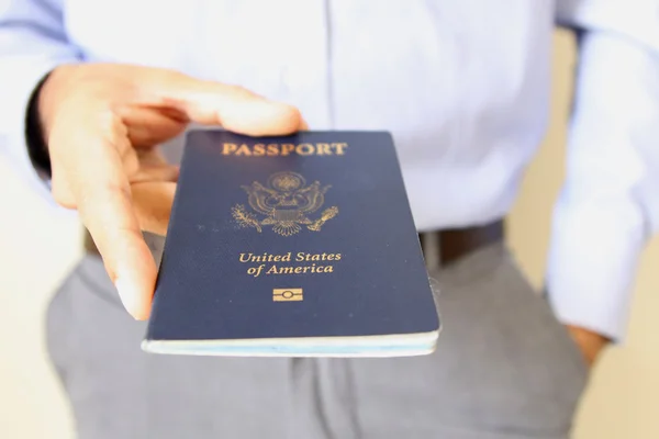 Image of a persons hand holding a passport — Stock Photo, Image