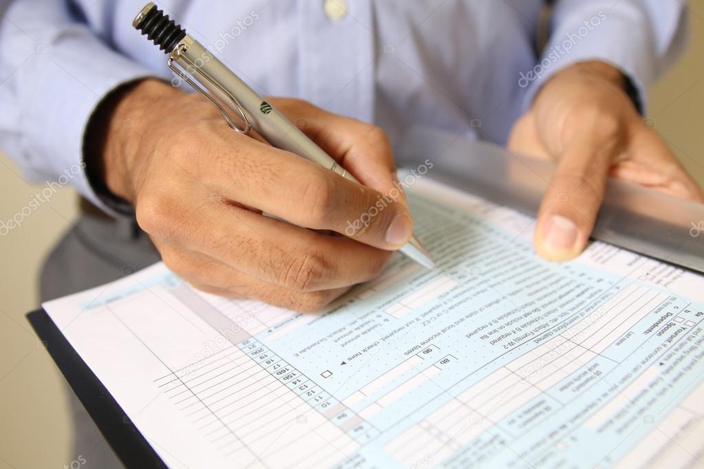 Businessman at office desk signing a contract