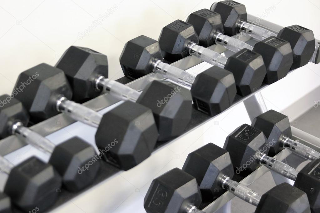 many dumbbells are at stand at the gym