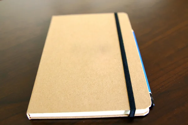 Light brown notepad book and pencil — Stock Photo, Image