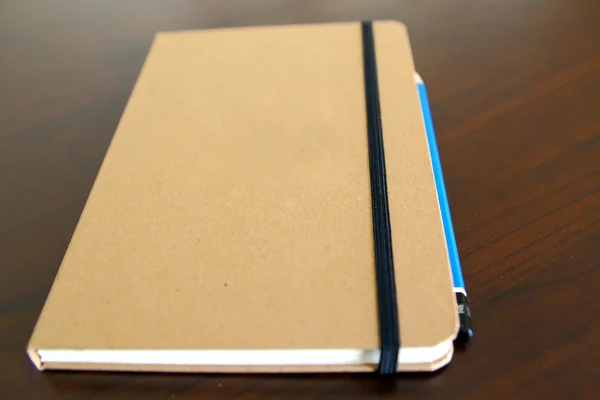 Light brown notepad book and pencil — Stock Photo, Image