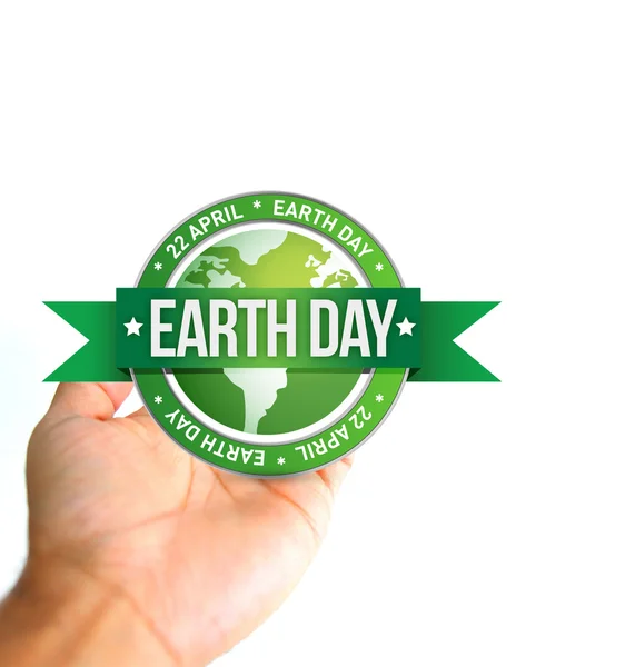 Hand holding a earth day seal. — Stock Photo, Image