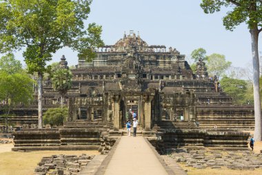 Baphuon Temple  with clear blue sky and tourists, Cambodia