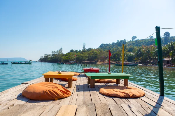 Harbor of Koh Rong with empty table and chairs on the Pier. Camb — Stock Photo, Image