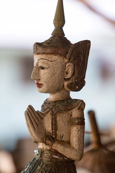 Antique Buddha statue with bokeh background, Thailand Stock Picture