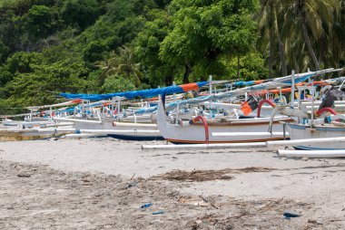 Traditional fisher boats at beautiful Candidasa beach in Bali, I clipart