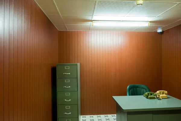 Old desk and chair in small office with vintage rotary phones, S