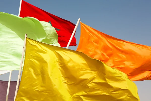 Flags of Morocco waving against blue sky — Stock Photo, Image