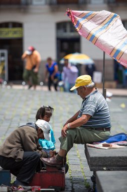 shoeshiner at work in Quito, Ecuador