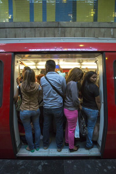 People standing in subway during rush hour, Caracas