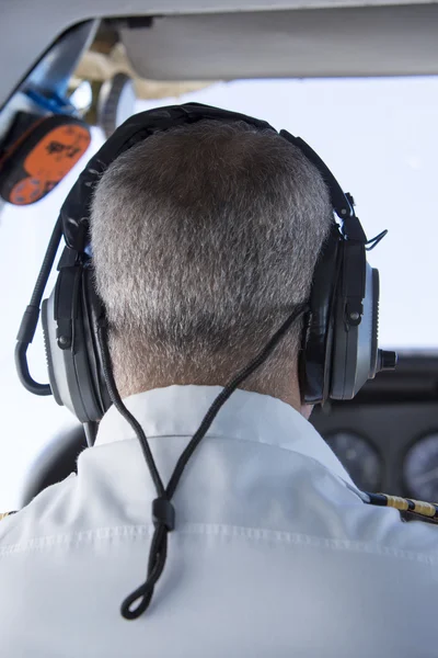 Piloto vestindo uniforme com epauletas durante a decolagem em p pequeno — Fotografia de Stock