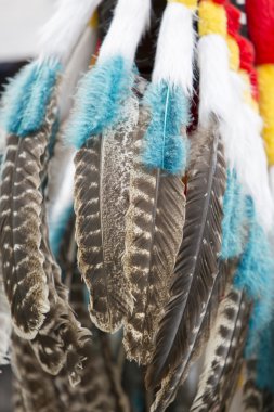 Background of colored hanging feathers in Andean craft market
