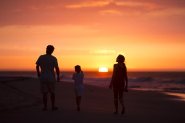 silhouette of family on the beach at dusk in Peru