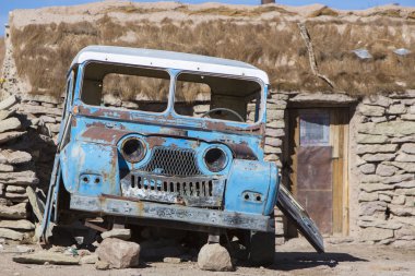 Broken 4x4 parked in front of rural stones house, Bolivia