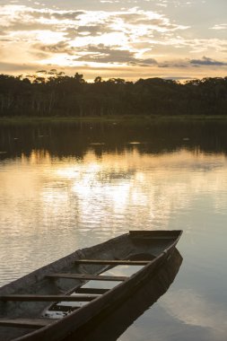 Sunset on a lake with canoe, Madidi National Park. Bolivia