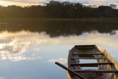 Sunset on a lake with canoe, Madidi National Park. Bolivia