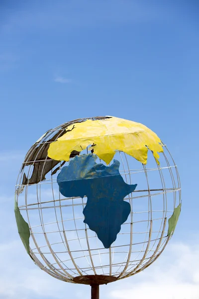 Iron earth globe structure with blue sky and African continent — Stok fotoğraf