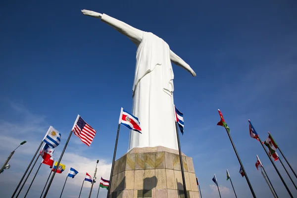 Cristo del Rey statue of Cali with world flags and blue sky, Col — Stock Photo, Image