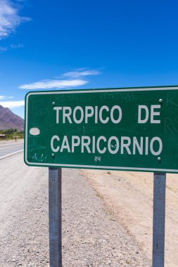 Tropic of Capricorn sign against a clear blue sky
