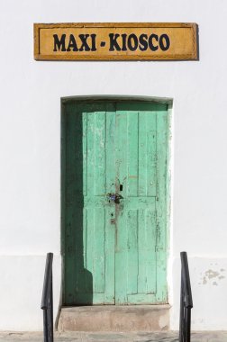 White wall and green old doors in Cachi, Argentina