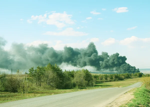 Erupción y conflagración, humo negro de las emisiones contaminantes — Foto de Stock