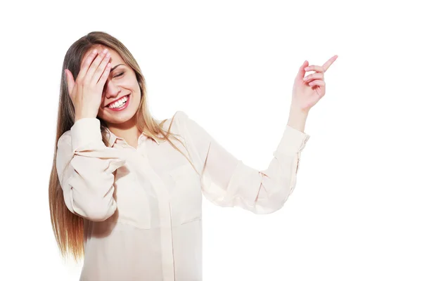 Laugh teenage girl pointing to the side — Stock Photo, Image