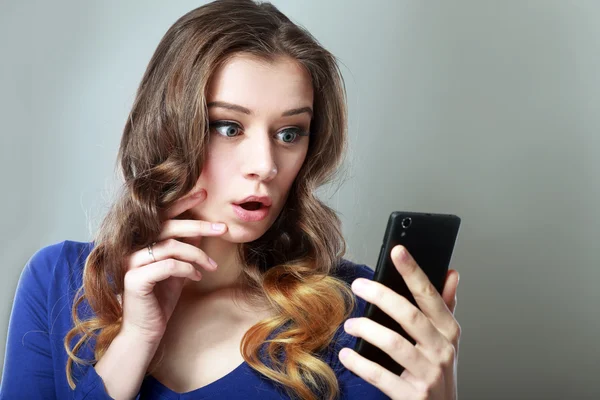 Girl looking at phone — Stock Photo, Image