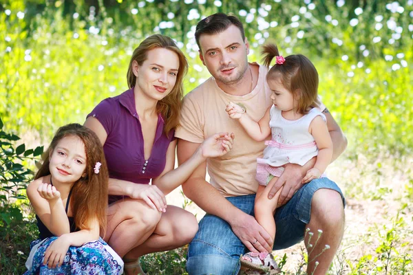 Happy family on field — Stock Photo, Image