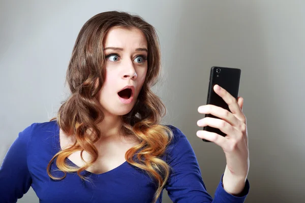 Girl looking at phone — Stock Photo, Image