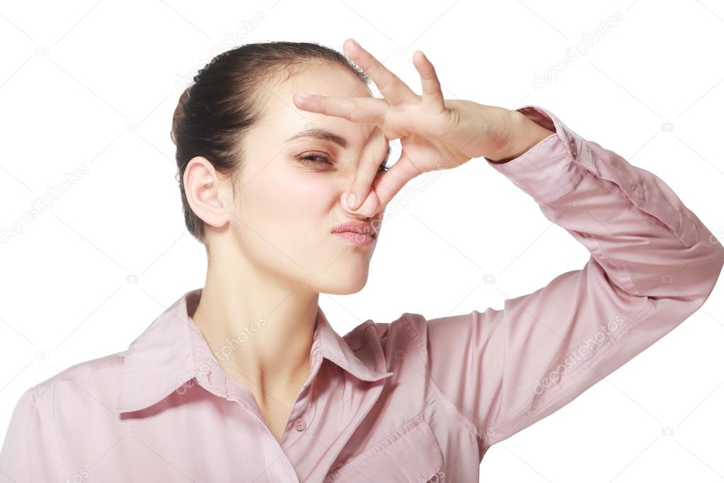 Young woman holding her nose Stock Photo by 119945012