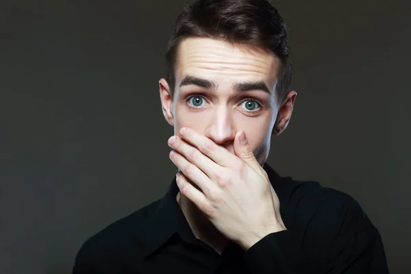 Scared man with hand covering his mouth — Stock Photo, Image