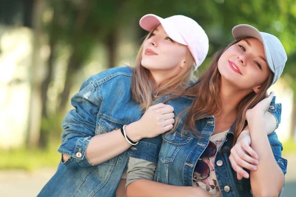 Young friends in caps — Stock Photo, Image