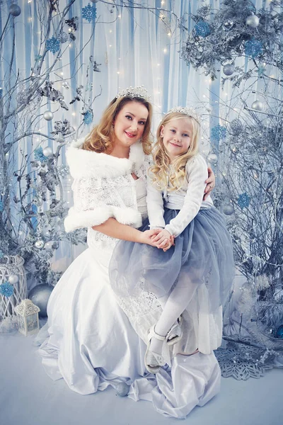 snow fairy tale snow queen and princess mother and daughter in magic winter forest