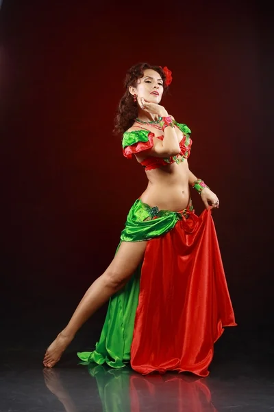 Woman dancing in green and red costume — Stock Photo, Image